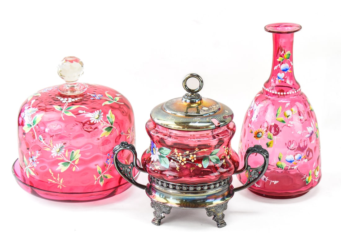 VICTORIAN FLORAL ENAMEL PAINTED CRANBERRY GLASS: MOSER (ATTR.) & MORE: This lot includes the following Victorian floral enamel-painted cranberry glass pieces, circa late 19th century: sugar cube castor on an Aurora Silver Plate Manufacturing Company stand, inverted coin 