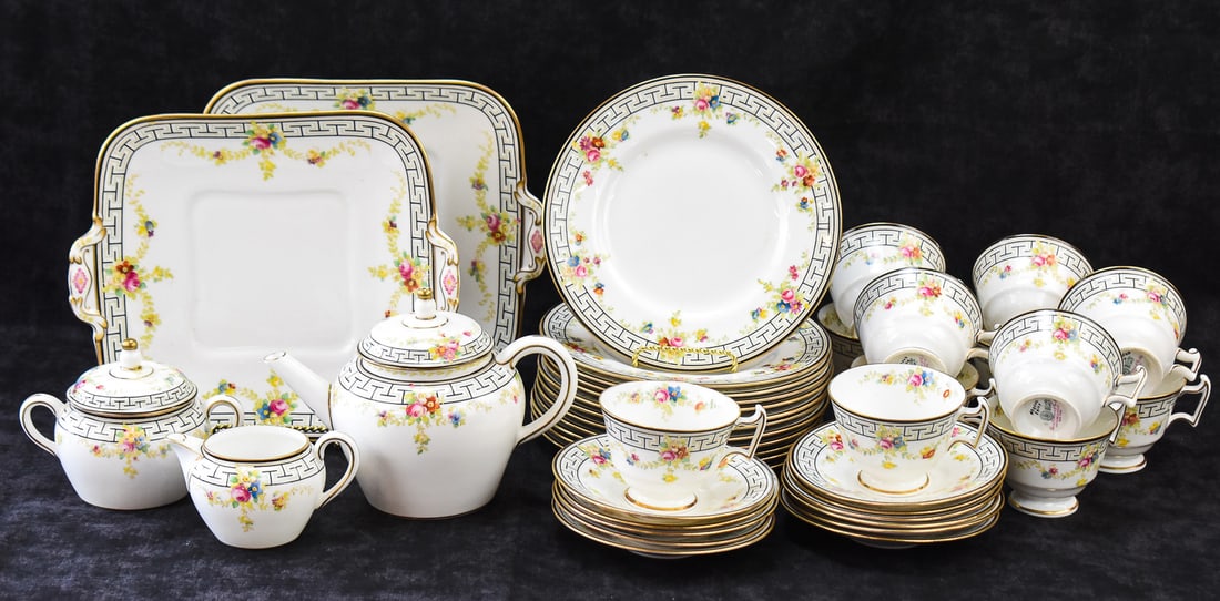 ROYAL DOULTON FOR DAVIS COLLAMORE & COMPANY, PATTERN E9169 BONE CHINA SET, CIRCA 1914: A Royal Doulton for Davis Collamore and Company bone china dishware set in the E9169 pattern with Greek key designs, floral swags, and gold trim, produced circa 1914. The base of the pieces are marked