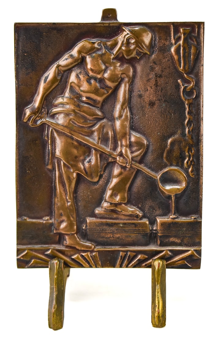 AFTER KARL KORSCHANN "DER GIEBER" OR "THE METALSMITH" BRONZE RELIEF SCULPTURE: "Der Gieber" or "The Metalsmith" a bronze relief sculpture after the design by Karl Korshann (1872-1943). This bronze sculpture is believe to be made by Quality Brass & Aluminum Foundry of Portland,