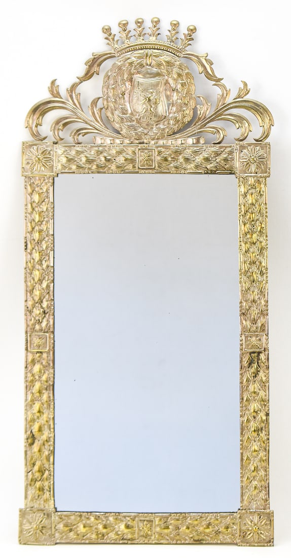 EUROPEAN PUNCHED TIN MIRROR: A punched tin border mirror with European design elements such as a laurel wreath, griffin coat of arms, crown elements, and Spanish-colonial influences, circa late 19th to early 20th century. The