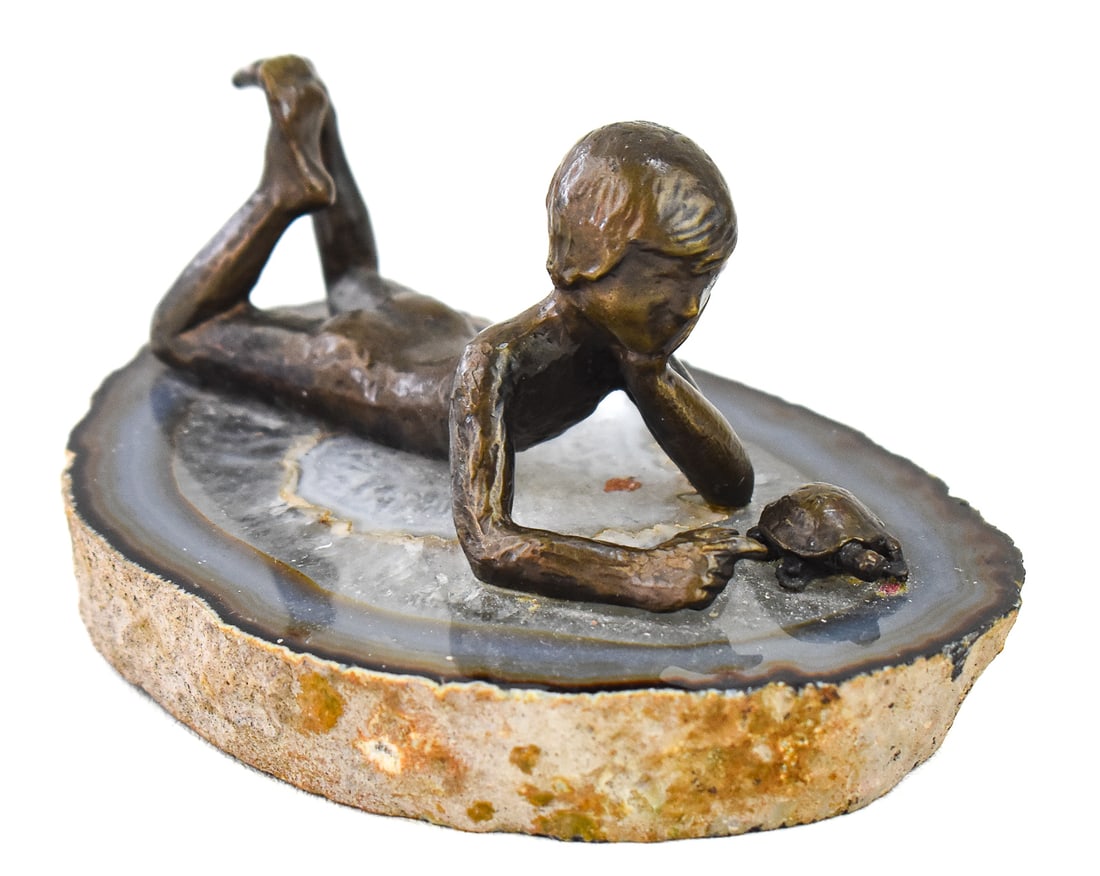 WAH M. CHANG SIGNED "BOY WITH TURTLE" PATINATED BRONZE SCULPTURE: A Wah Ming Chang (Listed Chinese-American artist, 1917-2003) signed "Boy with Turtle" patinated bronze sculpture on geode base, with an artist booklet. The item measures 2" H, 5" W, 2" D.