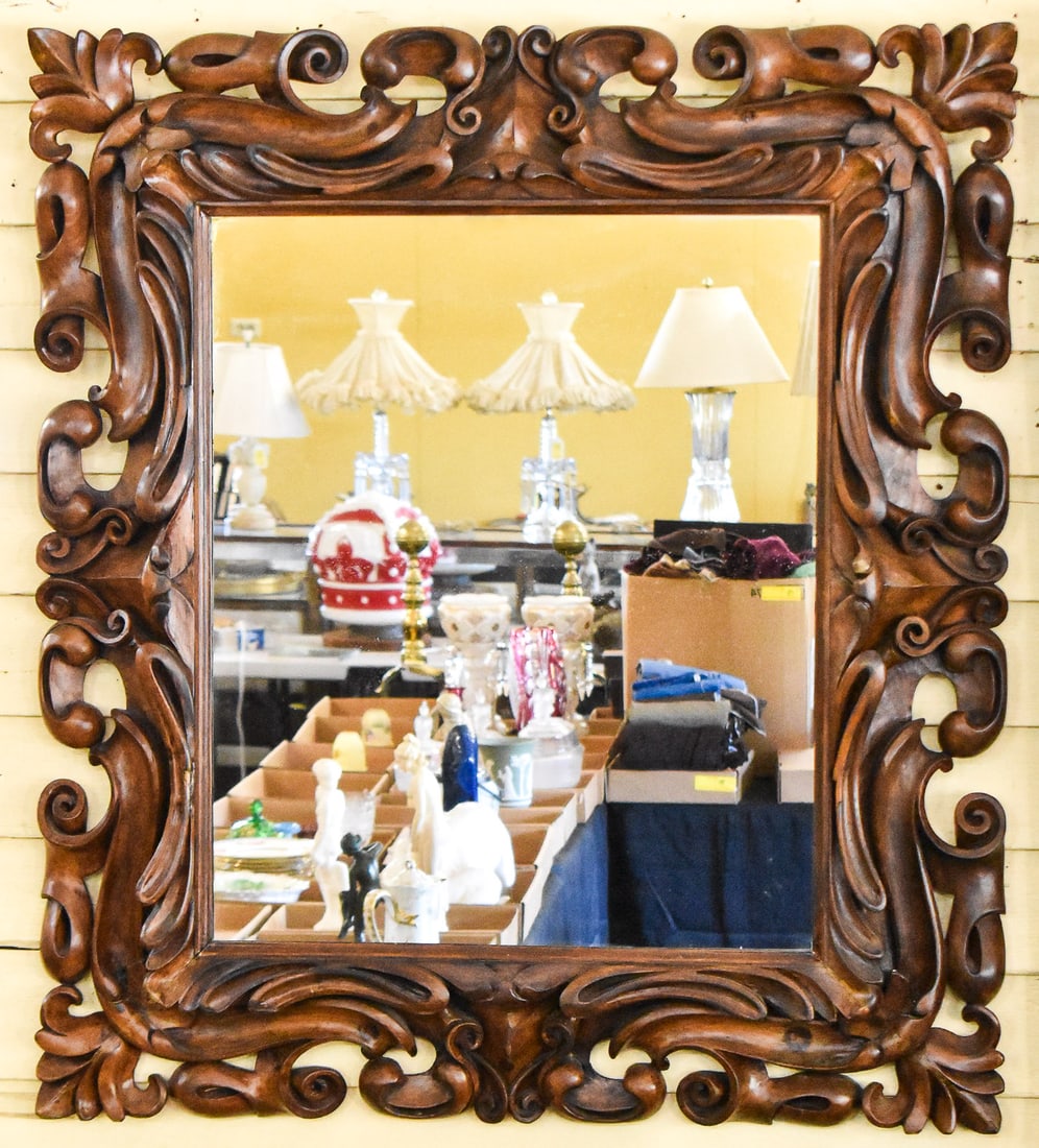 SPANISH COLONIAL ROCOCO STYLE WALL MIRROR: Mirror frame is made of walnut and carved into a heavy scroll design. Mirror has the measurements of 46" H x 40" W x 5" D.