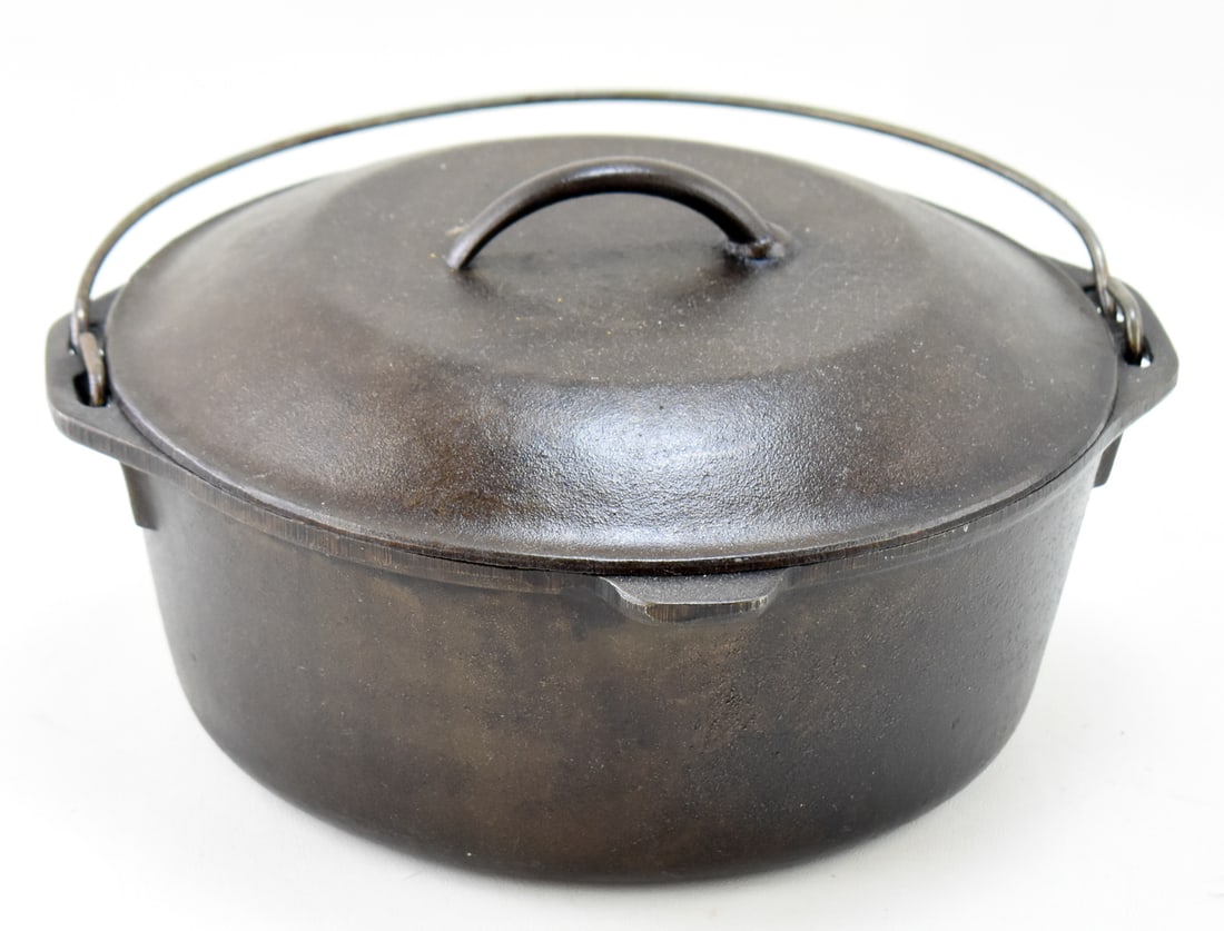 LODGE NO. 8 CAST IRON DUTCH OVEN, C. 1960s-1980s: A Lodge No. 8 cast iron Dutch oven, made circa 1960s-1980s. The underside of the lid is marked "10 1/4" and "8", and the base is marked "8", "DO", and "MADE IN USA". The Dutch oven measures approx. 5.