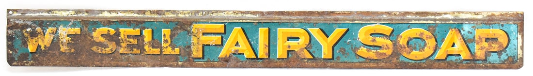 "WE SELL FAIRY SOAP" SINGLE-SIDED METAL ADVERTISING SIGN: A single-sided painted metal "We Sell Fairy Soap" advertising sign, circa early 20th century. The sign measures approx. 2" H x 18" W x 0.5" D.