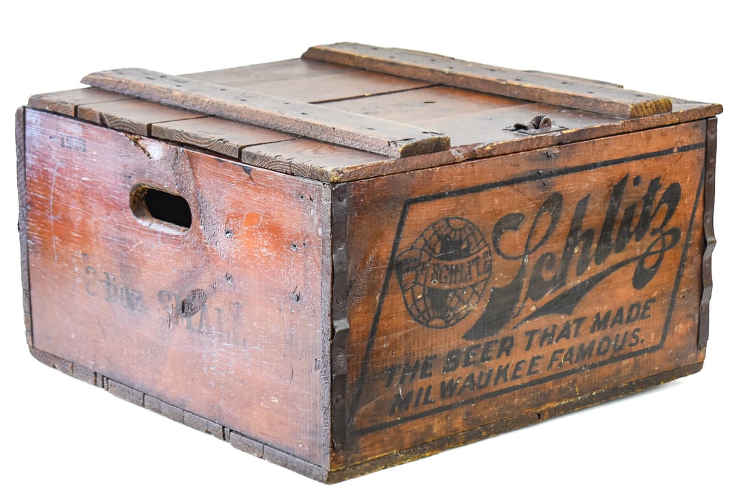 SCHLITZ BEER WOODEN CRATE: This crate has a hinged lid and would hold 24 longneck bottles. The slogan "The Beer That Made Milwaukee Famous" painted on the front. The crate was made circa 1930s-1940s and measures approx. 12" H x