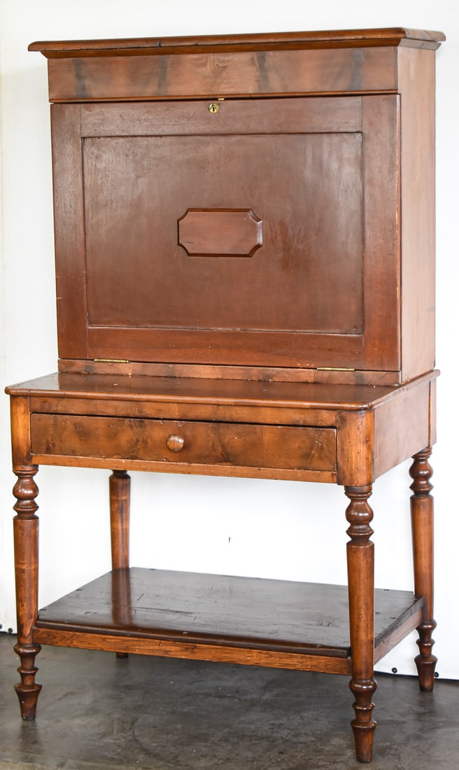 AMERICAN SHERATON PLANTATION DESK: This desk is made of cherry wood and features a fall front door with key and a felt writing surface. Desk was built circa early to mid 19th century and measures approx. 59" H x 33" W x 22" D.
