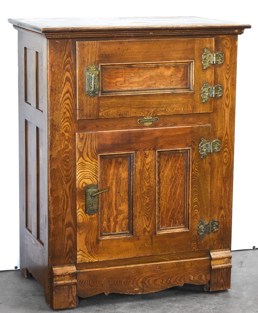 ANTIQUE LEONARD CLEANABLE OAK ICE BOX: An early 20th century "Leonard Cleanable" oak ice box measuring approx. 46" H x 33.5" W x 21" D.