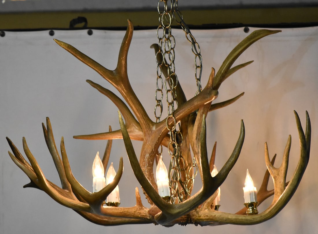 ANTLER CHANDELIER: Antlers are made of a realistic resin, so they are faux. Chandelier has 3 hanging points with 5 lights. Chandelier measures approx. 18" H x 27" W x 27" D.