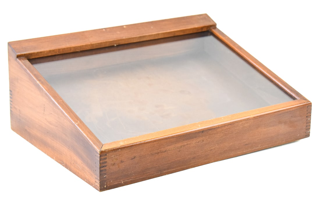 COUNTERTOP WOOD AND GLASS TOP DISPLAY CASE: A countertop wood and glass top display case with a back latching door, measuring approx. 7" H x 18" W x 13" D.