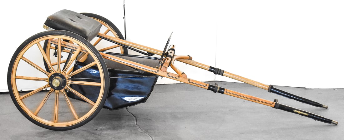 SULKY EDUCATING CART: This cart has been refinished with a clearcoat and black pin stripping. Appears to have pleather foot cubby and splash guard. Manufactured by Houghton Sulky Inc. The cart measures approx. 30" H x 84"