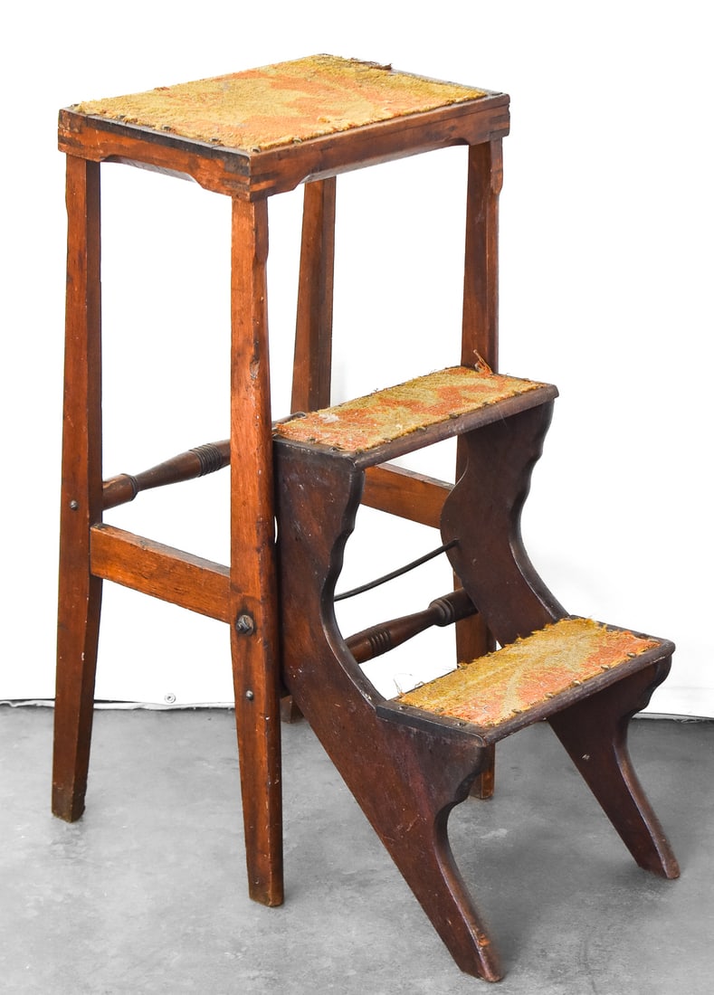 ANTIQUE WALNUT LIBRARY STEPS: An antique walnut folding library step. It is finished with carpet and decorative nail heads on the landing. When closed the item measures approx. 29" H x 15" W x 10" D.