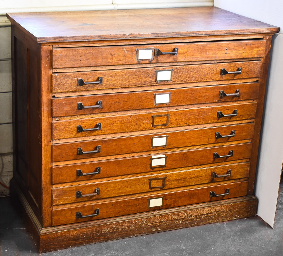 20TH CENTURY OAK MAP CABINET: This oak cabinet includes eight shallow drawers for the storage of maps, blueprints and other large paper products without rolling or folding. It measures approx. 42" H x 49" W x 26" D.