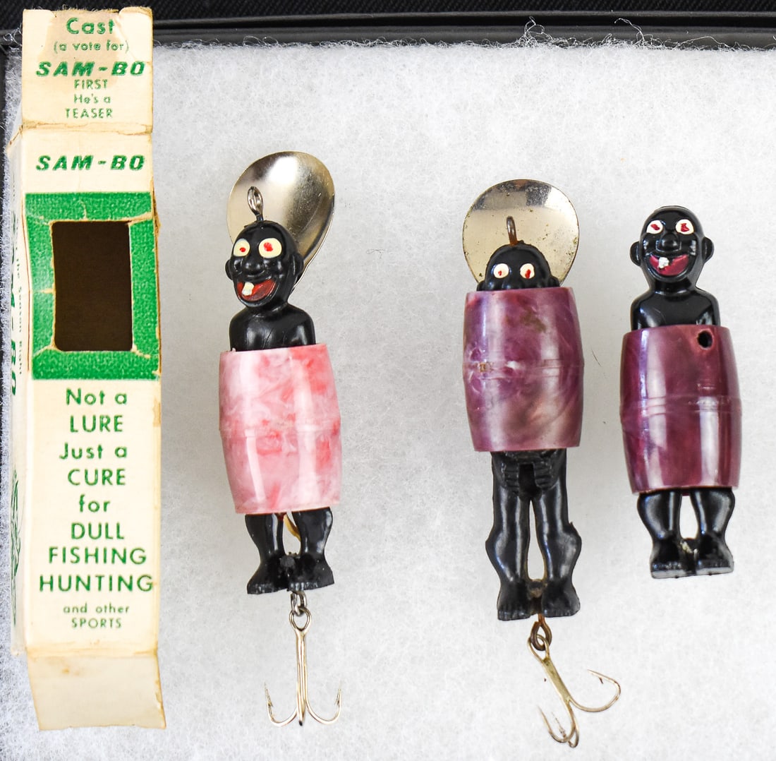 THREE "THE GLOOM KILLER" SAM-BO BLACK AMERICANA FISHING LURES: A set of three "The Gloom Killer" Sam-Bo Black Americana fishing lures, made by the Novelty Lure Company circa 1950s. One of the lures comes in the original box, and the last one is not equipped with