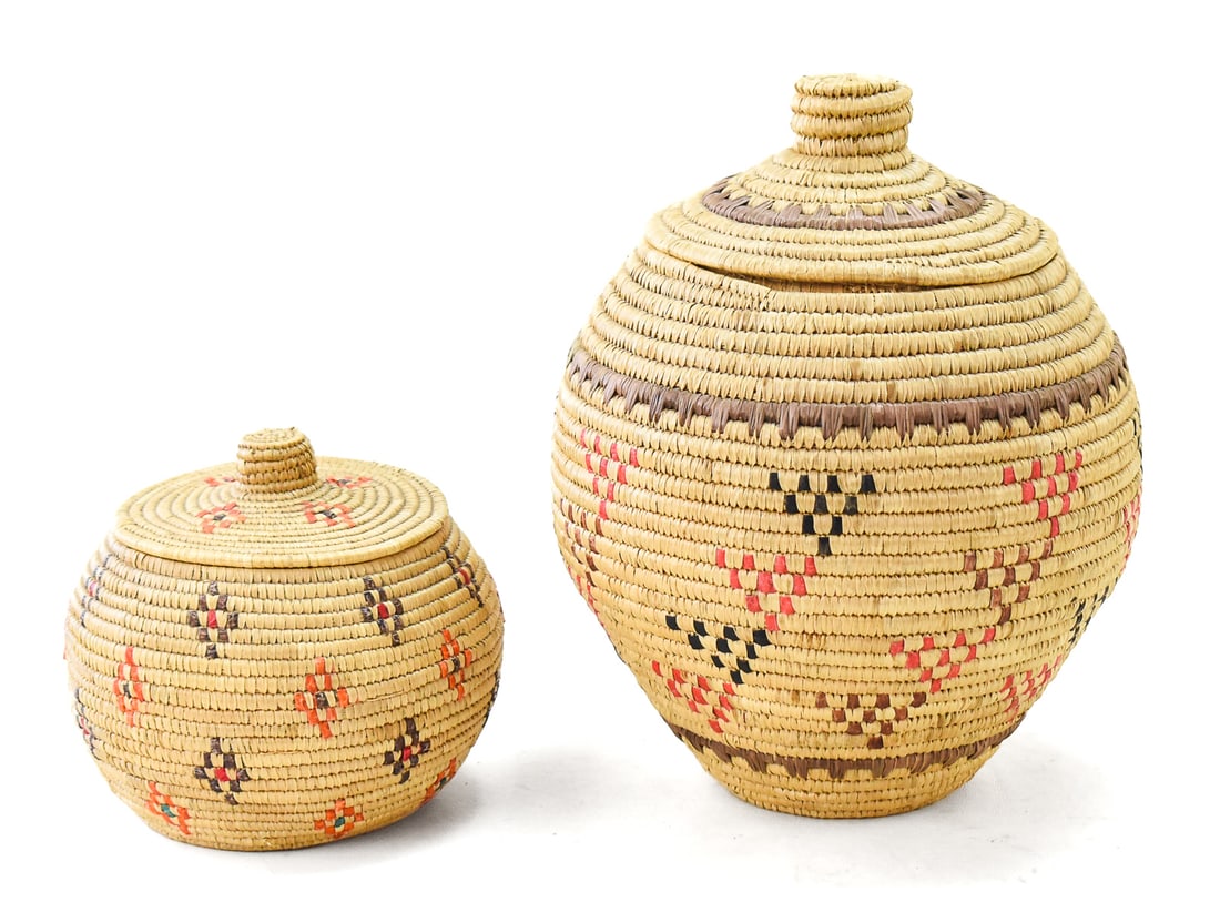 PAIR OF YUPIK LIDDED BASKETS: This baskets are both Alaskan Native hand made with beach grass during the 20th century. The smaller one contains a collection of obsidian rock pieces. The taller of the two measures approx. 10" H x 7