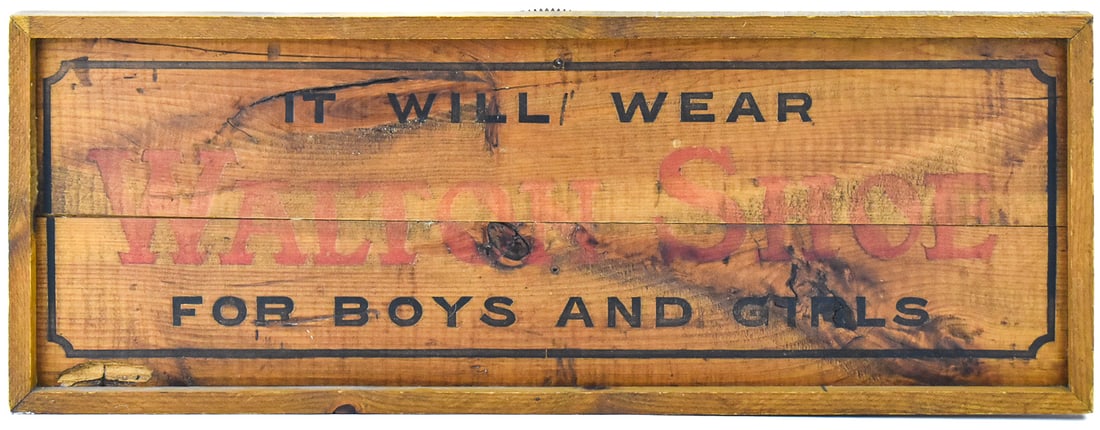 SALVAGED WALTON SHOE CRATE SIGN: A shipping crate from Walton Shoes turned into a hanging sign. The item is made of natural wood with hand painted on letters and measures approx. 13" H x 35" W x 1.5" D.