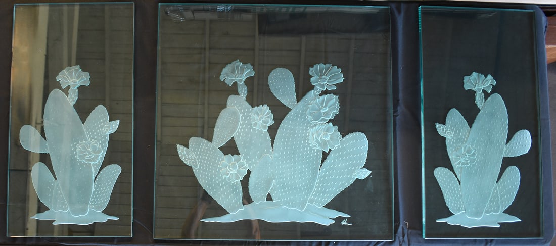 NOLAN EVERITT (ATTR.), PRICKLY PEAR CACTUS SANDBLASTED GLASS TRIPTYCH: This set of three glass panels has been carved using the sandblasting technique. It features a signature in the bottom right corner attributed to Nolan Everitt. The largest panel measures approx. 28"
