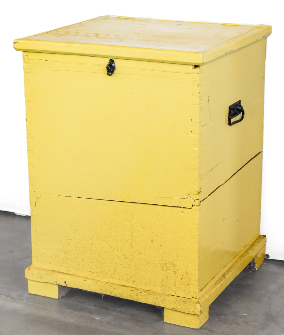 EARLY TO MID 20TH CENTURY PRIMITIVE GRAIN BIN: This painted yellow bin has an outer structure made of wood with an inner lining of metal meant to protect its contents from water or rodent damages. It measures approx. 29.5" H x 21" W x 20.5" D.