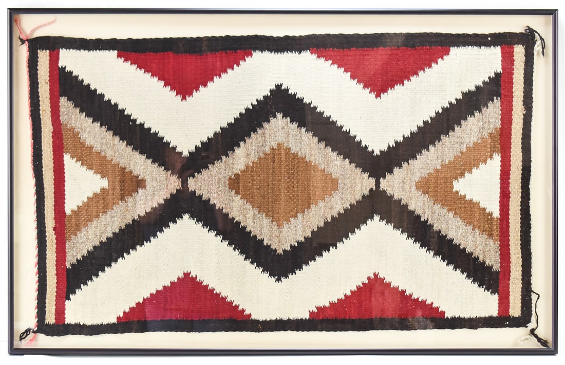 FRAMED NAVAJO RUG: This rug is from the mid 20th century in the pattern known as "Eye-Dazzler". The frame measures approx. 48.5" H x 30.5" W x 1.5" D.