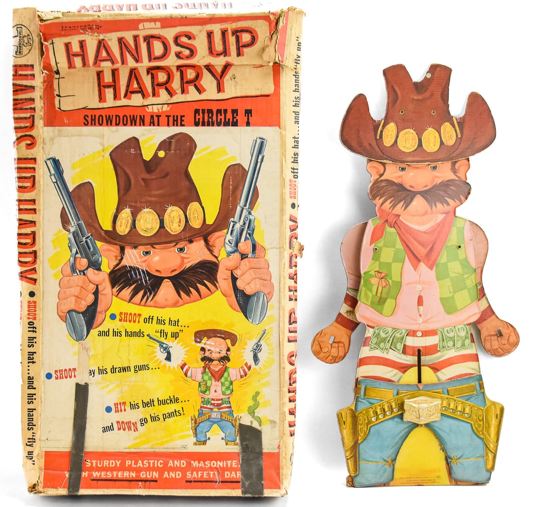 HANDS UP HARRY: Hands Up Harry is a mechanical target shooting game produced by Transogram in 1964 and 1965. Harry is made of plastic coated Masonite and in the box measures approx. 30.5" H x 16.5" W x 4&qu