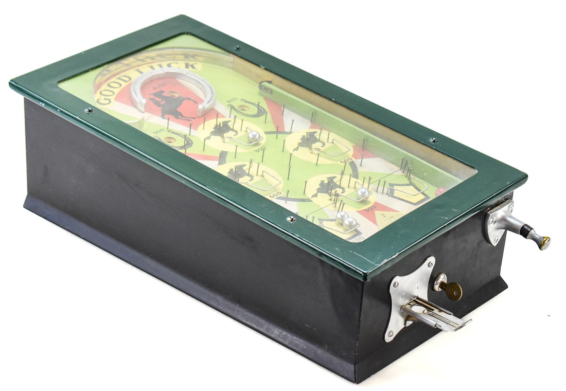"GOOD LUCK" TABLETOP PINBALL GAME: This equestrian themed mechanical tabletop pinball machine was manufactured by Genco Manufacturing Co. in 1932. The unit measures approx. 7" H x 12.5" W x 22.5" D.