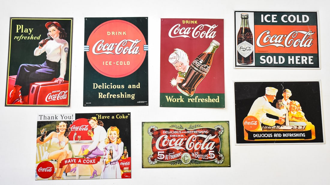 COLLECTION OF COCA-COLA METAL SIGN ADVERTISEMENTS: Includes seven metal signs reproduced circa 1995 from different eras of Coke advertising. The largest measures approx. 17" H x 12" W x 0.5" D.