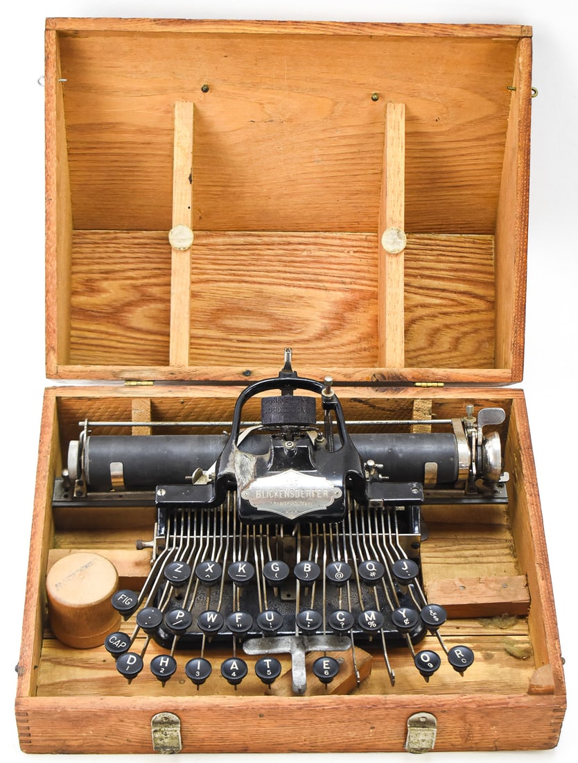 BLICKENSDERFER NO. 5 TYPEWRITER IN WOODEN CASE, CAPT. GEORGE W. POVEY, CIRCA 1896: A Blickensderfer No. 5 typewriter with an original wooden case, produced in Stamford, Connecticut circa 189 with serial number 40706. There is a metal plaque on the front with the brand, model