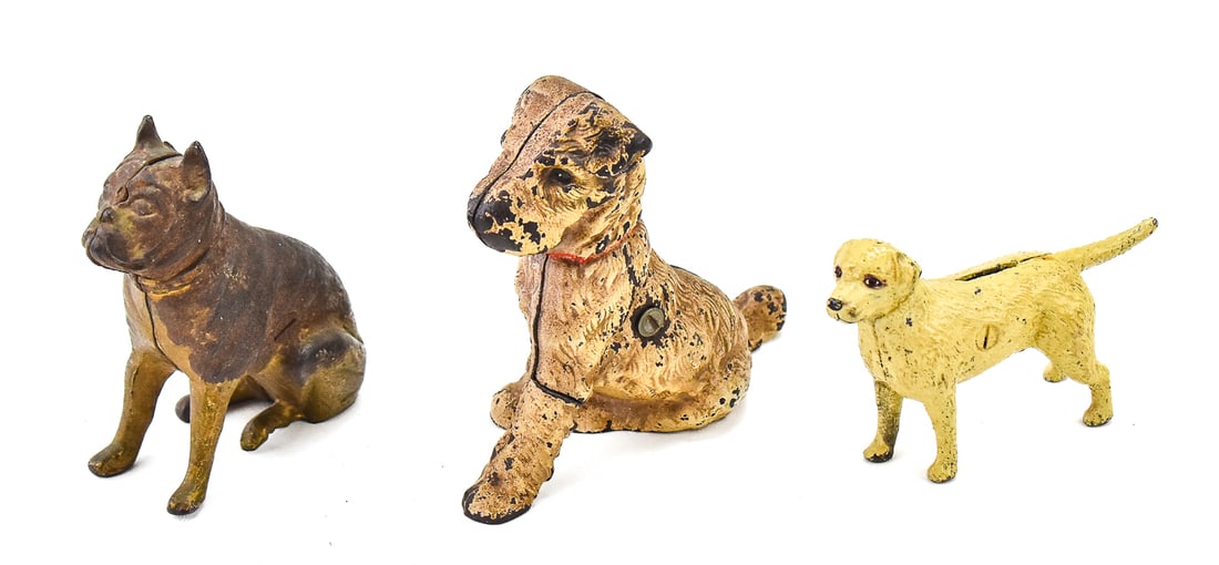 THREE DOG STILL BANKS: HUBLEY & MORE: This lot includes three dog still banks: Hubley wire-haired fox terrier marked "825", Hubley style French bulldog, and a standing golden Labrador. The largest item measures approx. 5" H x 2" W x 6" D.