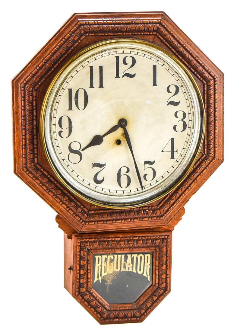 E. INGRAHAM COMPANY DROP OCTAGON REGULATOR WALL CLOCK, C. LATE 19TH/EARLY 20TH CENTURY: An E. Ingraham Company drop octagon regulator wall clock, made in Bristol, Connecticut circa late-19th/early-20th century. The clock features a reverse painted lower panel that reads "Regulator", a Vi
