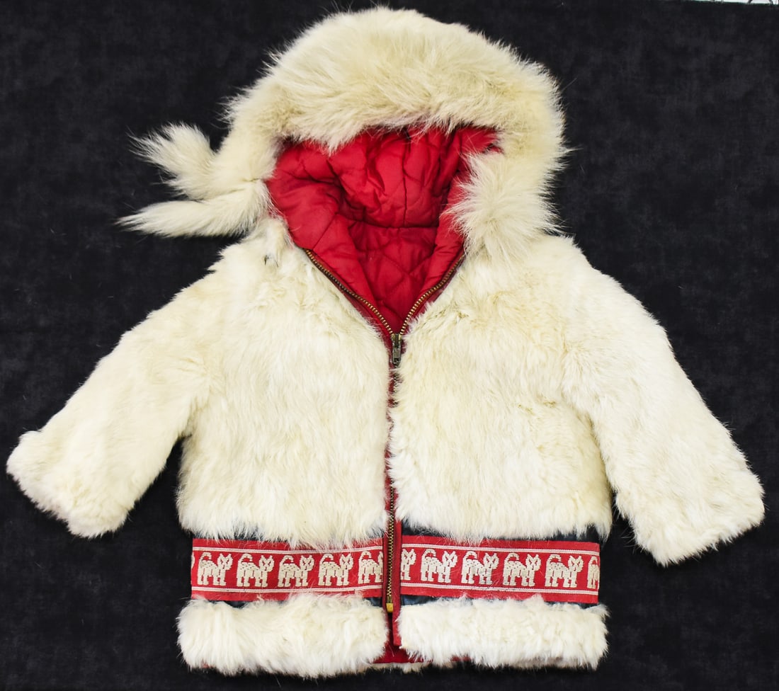 INUIT-STYLE CHILD'S PARKA: This garment is made of a rabbit fur exterior and a satin type material for a lining. There is an animal motif on the trim. Parka dates to around the mid 20th century. Garment has a measurement of