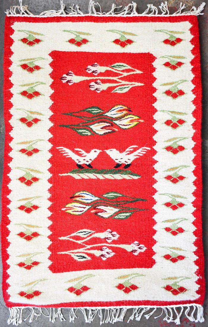 RED & WHITE HANDWOVEN WOOL KILIM RUG ON FRAME: A red and white handwoven wool kilim rug on frame. The rug has a bird and flower design and measures 33"H x 23"W x 1"D.