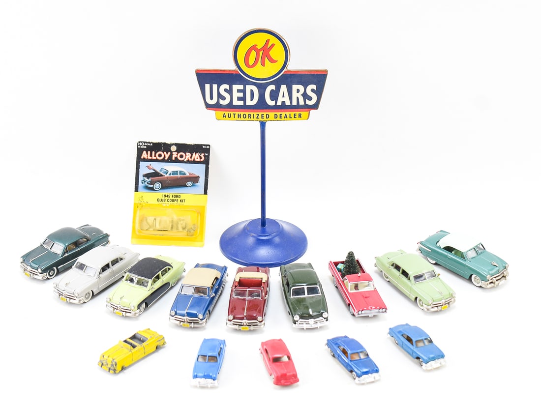 15 TOY CAR COLLECTION: This collection consists of 6 different toy manufactures and a reproduction Chevrolet "OK Used Cars" advertisement. 4 (1 large 3 small) ERTL Manufacturing, 1 Brooklin Models, 6 Motor City USA 1:43 sca
