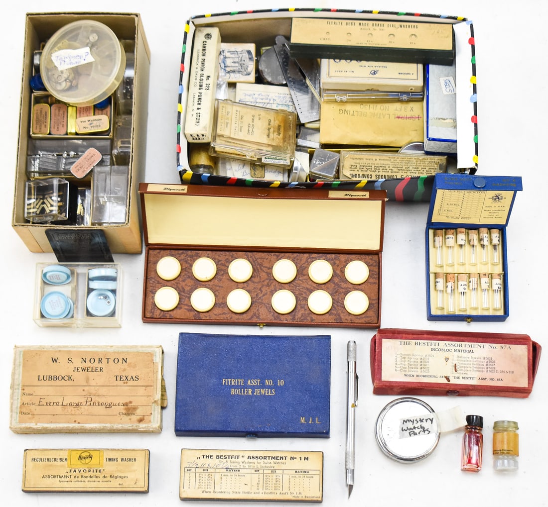 ASSORTMENT OF MISCELLANEOUS WATCH PARTS & TOOLS: An assortment of miscellaneous watch parts and tools including washers, screws, crowns, watch oil, a roller remover, pinion closing punches, and more. The largest box of parts measures 3.5" H x 10" W