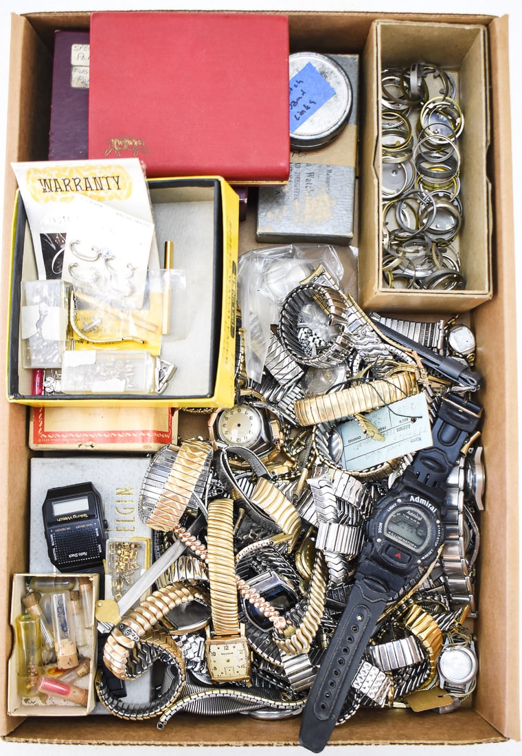 ASSORTMENT OF WATCH PARTS: BANDS, LINKS, SPACER RINGS: A large assortment of watch parts including many watches in need of repair, watch bands, band links, dust covers, movement spacers, spring bars, and band repair tools. The largest box measures 2" H x