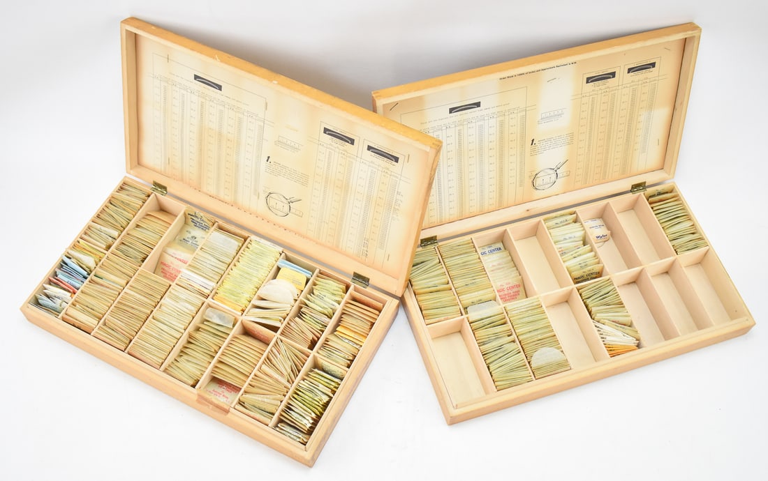 DUTCHER BROS. "THE MAGIC CRYSTAL WITH A DIAMOND EDGE" WATCH CRYSTAL REPLACEMENT SETS: A pair of Dutcher Bros. "The Magic Crystal with a Diamond Edge" watch crystal replacement sets. This lot includes hundreds of watch crystals for watch repair of varying sizes. Each box measures 2.5"