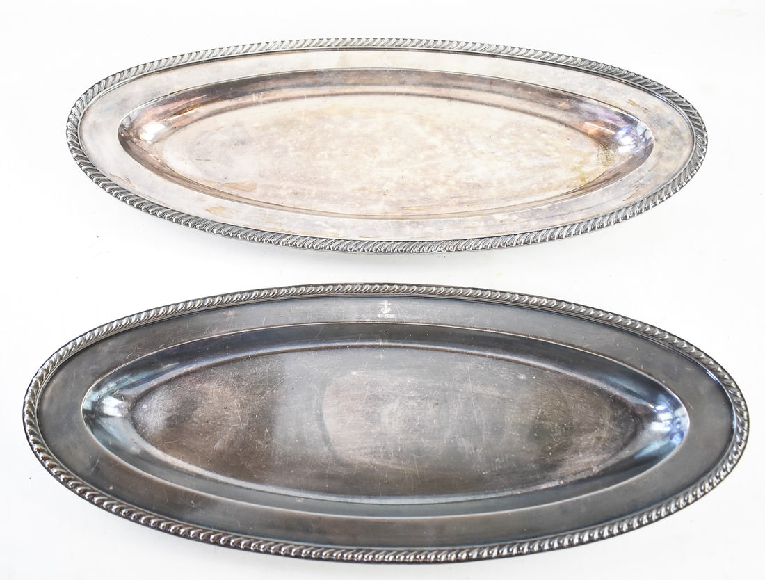 PAIR OF U.S. NAVY REED & BARTON SILVER SOLDERED OVAL PLATTERS: A pair of very generous sized Reed & Barton silver soldered oval platters used for the U.S. Navy. They have a stamped anchor on the rim of the top and are stamped on the underside with 0121-H 2 4.