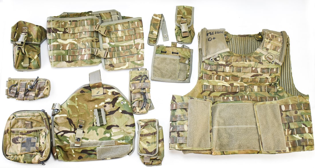 BRITISH ARMY OSPREY MK4 PLATE CARRIER AND BODY ARMOUR SYSTEM: A British Army Osprey MK4 plate carrier, pouches, and modular add-ons, circa 2010. The plate carrier is marked by a soldier MC1806 and O+ blood type. The plate carrier measures 20" H x 22" W x 6" D.