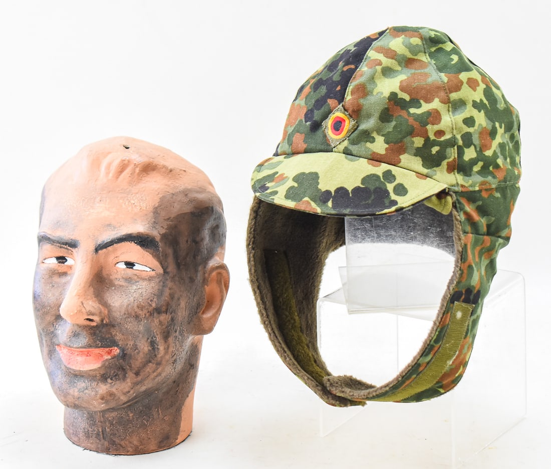 BUNDESWEHR FLECKTARN WINTER CAP: A Bundeswehr (German Military) Flecktarn pattern winter cap, made circa 1993. The cap measures approx. 11" H x 7" W x 10" D.