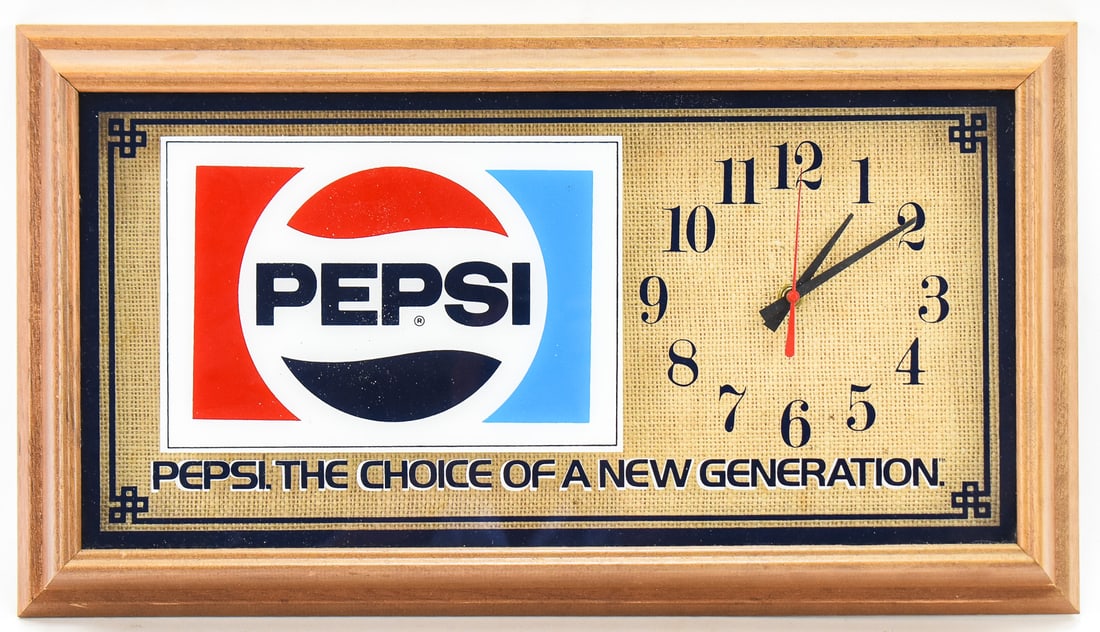 PEPSI WALL CLOCK: This Pepsi wall clock has a glass face inside a wooden frame. The caption "The choice of a new generation" was the companies slogan starting in 1984 and running until 1991. Measures 13" H x 23" W x 3"