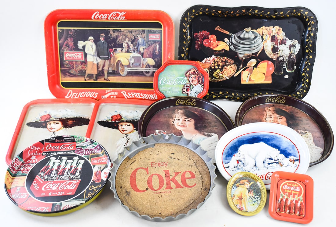 COLLECTION OF THIRTEEN COCA-COLA ADVERTISING TRAYS: A collection of thirteen circa 1960s-90s Coca-Cola advertising trays in various sizes, patterns and colors. The largest tray measures approx. 14" H x 19" W x 1" D.