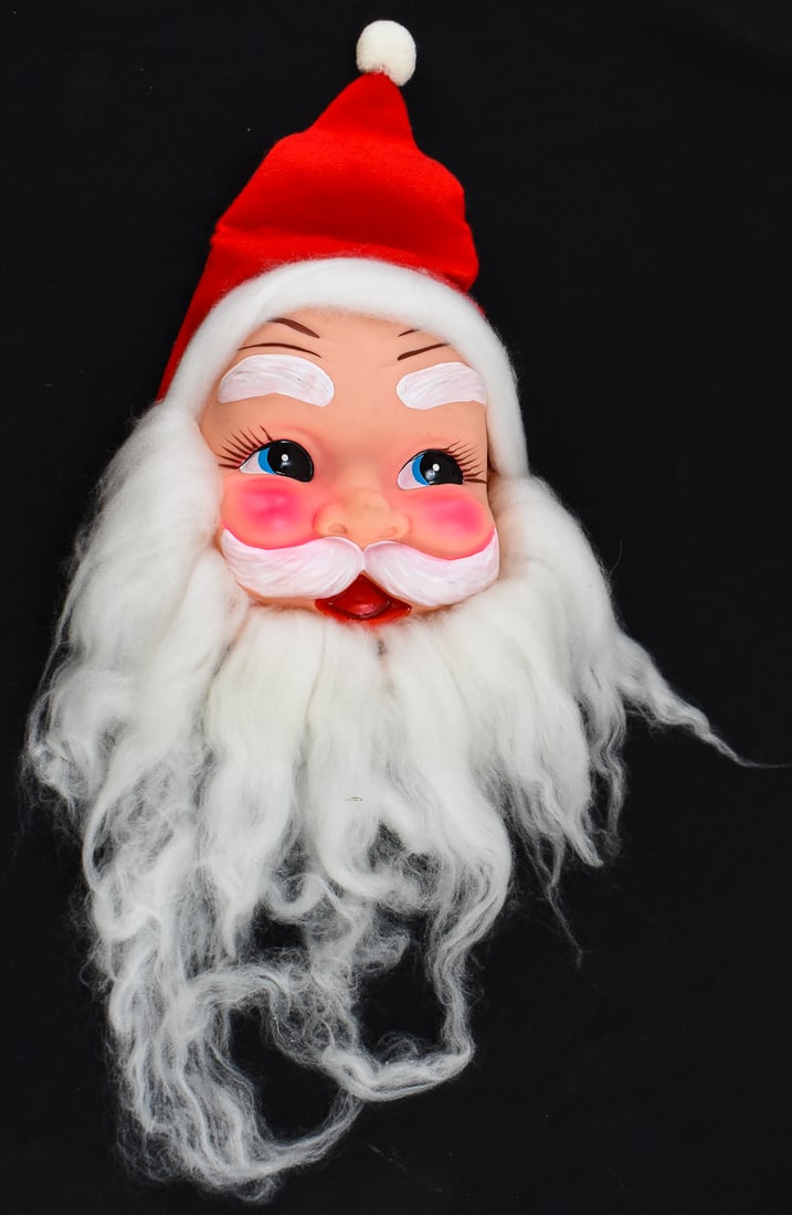 JAPAN-MADE RUBBER-FACE SANTA CLAUS: A Japan-made wall-hanging rubber-face Santa Claus, circa mid 20th century. The item measures 8" H, 6.5" W, 3" D.