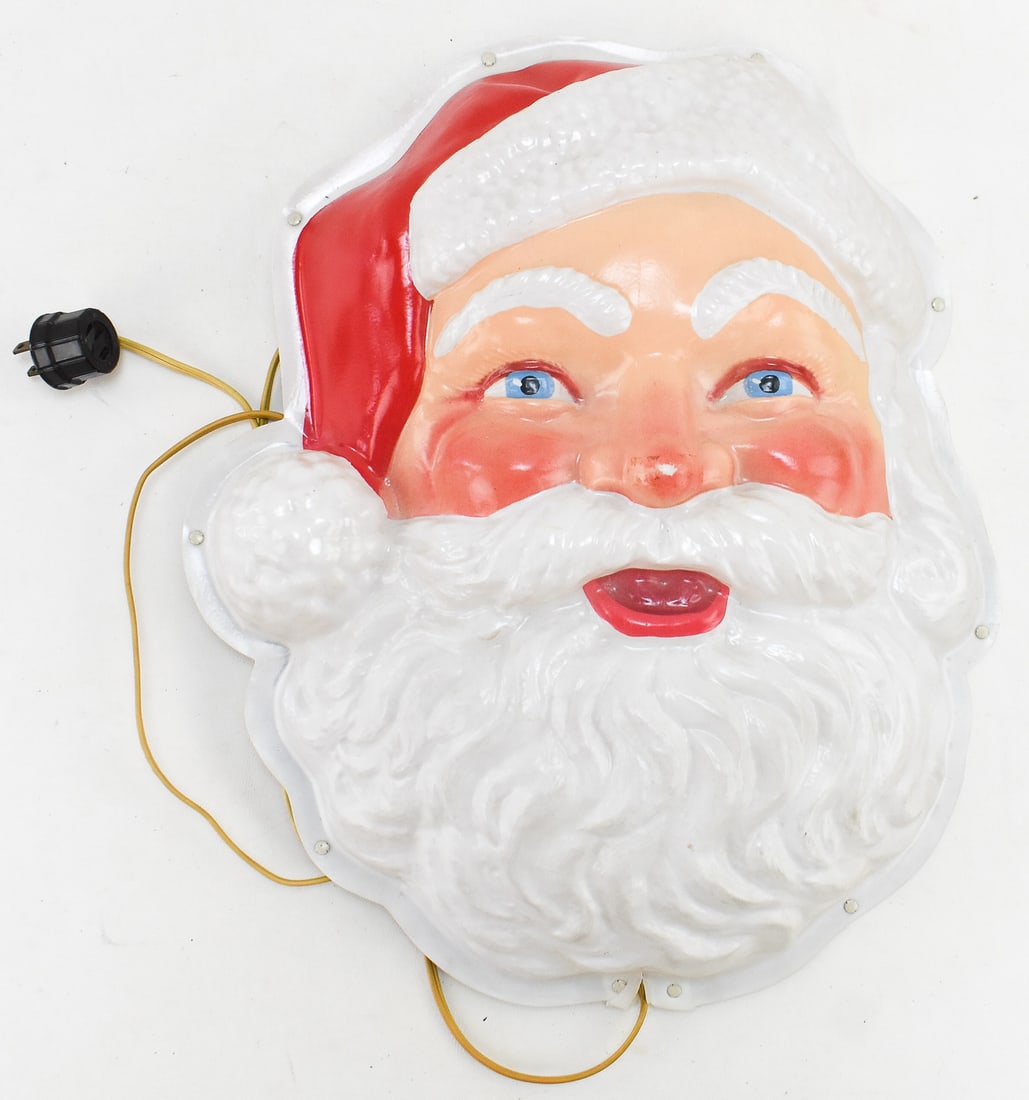 PARAMOUNT (ATTR.) LIGHTED SANTA CLAUS FACE: A Paramount (attributed) lighted plastic wall-hanging Santa Claus face, circa mid 20th century. The item measures 15" H, 13" W, 4" D.