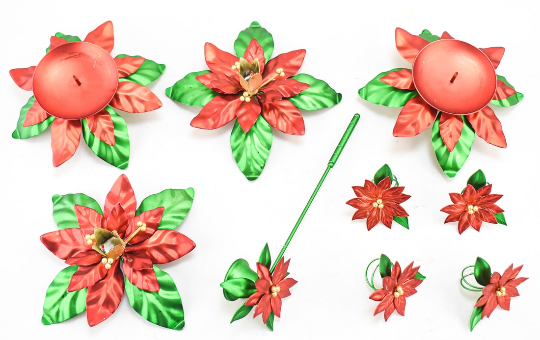 VINTAGE DEPARTMENT 56 POINSETTIA CHRISTMAS DECOR: Vintage Department 56 Poinsettia Christmas decor which includes a pair of pillar candle holders, tapered candle holders, four napkin rings and a candle snuffer.One of the sets measures approx. 3"H x 8