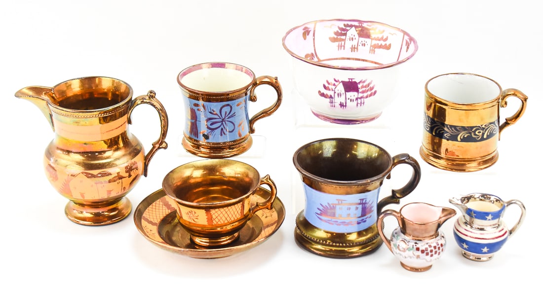 ENGLISH COPPER LUSTERWARE POTTERY ASSORTMENT: An assortment of English copper lusterware pottery from the late 19th century: four teacups, three creamers, one saucer, and one bowl. The largest item measures approx. 5.5" H x 6" W x 4" D.