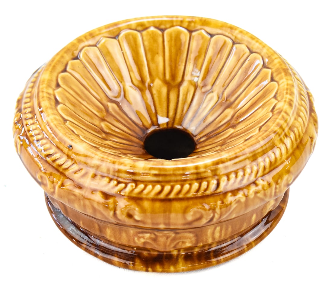 AMERICAN ROCKINGHAM-GLAZED SPITTOON CUSPIDOR: An American Rockingham-glazed ceramic yellow ware spittoon cuspidor featuring a raised fluting pattern, from mid-late 19th century. The item measures approx. 4" H x 8" W x 8' D.