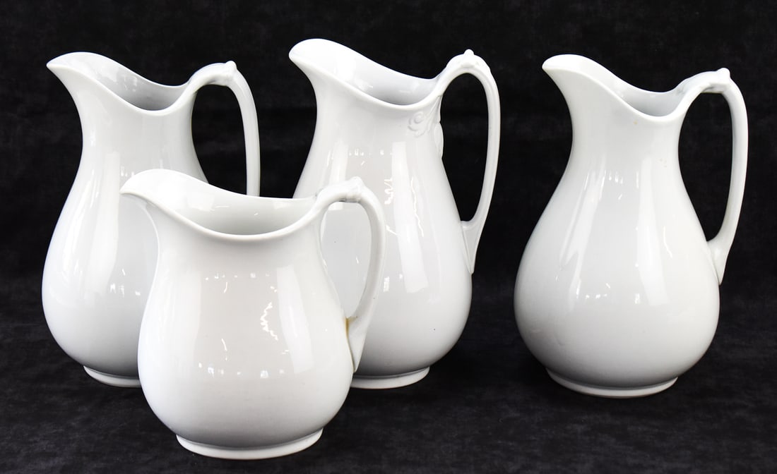 FOUR ENGLISH WHITE IRONSTONE PITCHERS: J & G MEAKIN, WEDGWOOD: This lot includes the following English white-glazed ironstone pitchers, from late 19th-early 20th century: three J. & G. Meakin (England) and one by Wedgwood. The largest item measures approx. 12