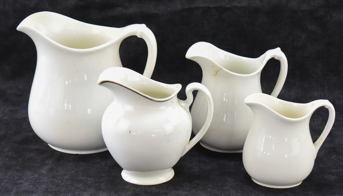 FOUR W.S. GEORGE "WHITE GRANITE" PITCHERS: This lot includes four W.S. George (OH/DE) "White Granite" pitchers, from early 20th century. The largest item measures approx. 9" H x 7" W x 7" D.