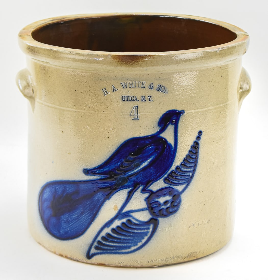 N.A. WHITE & SON FOUR-GALLON STONEWARE CROCK: A marked N.A. White & Son (Utica, NY) four-gallon stoneware crock with a cobalt bird motif, from between 1867-1882. Crock measures approx. 11" H x 13" W x 12" D.