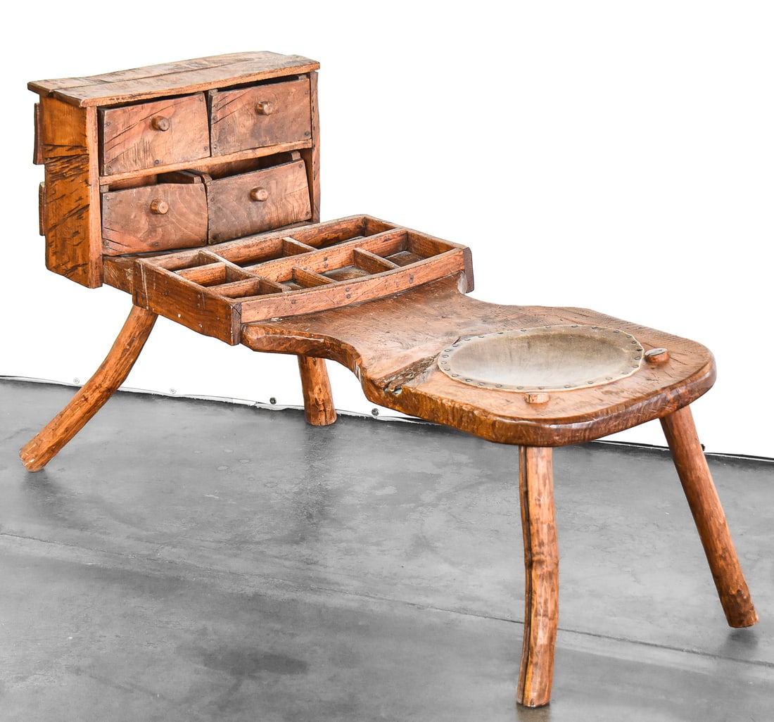 AMERICAN PINE COBBLERS' WORKBENCH: An American pine Cobbler's workbench featuring a leather saddle seat, four drawers, and tool tray; from early-mid 19th century. The bench measures approx. 27" H x 49" W x 20" D.