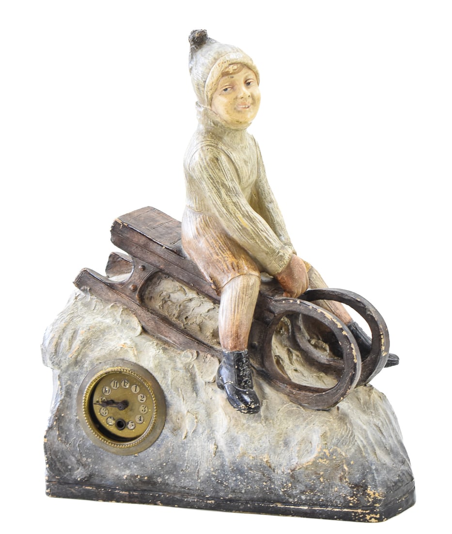 FIGURAL CHALKWARE MANTEL CLOCK OF CHILD RIDING SLED (1 of 2)