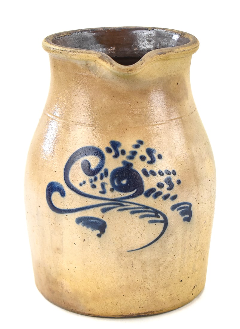 ONE GALLON STONEWARE PITCHER WITH COBALT FLORAL: This unmarked stoneware pitcher features a cobalt floral motif and measures approx. 10" H x 8" W x 7" D.
